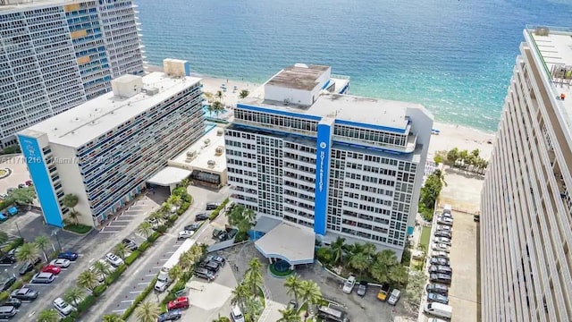 bird's eye view featuring a water view and a beach view