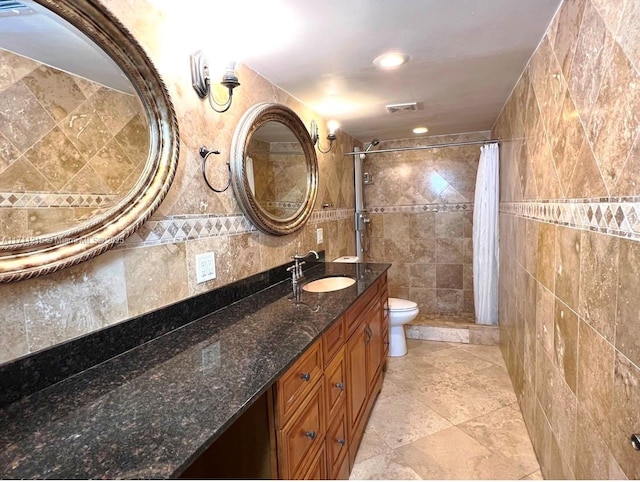 bathroom with vanity, toilet, tile walls, and a shower with curtain