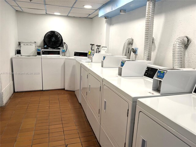 clothes washing area featuring washing machine and dryer and tile patterned floors