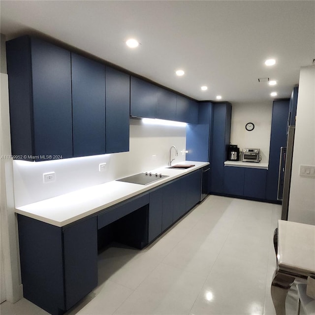 kitchen featuring light tile patterned flooring, black electric stovetop, blue cabinets, and sink