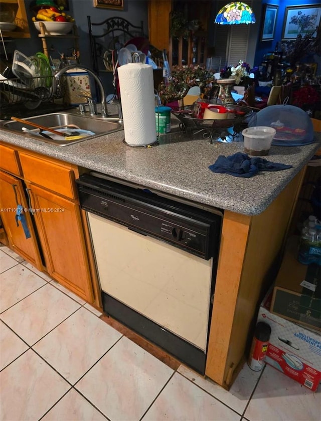 kitchen featuring sink, white dishwasher, and light tile patterned floors