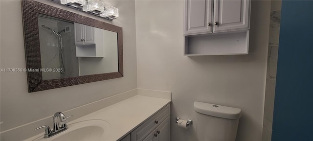 bathroom with vanity, toilet, and walk in shower