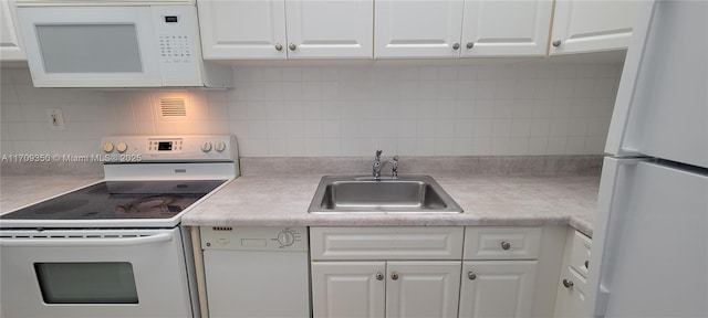 kitchen featuring white appliances, sink, white cabinets, and decorative backsplash