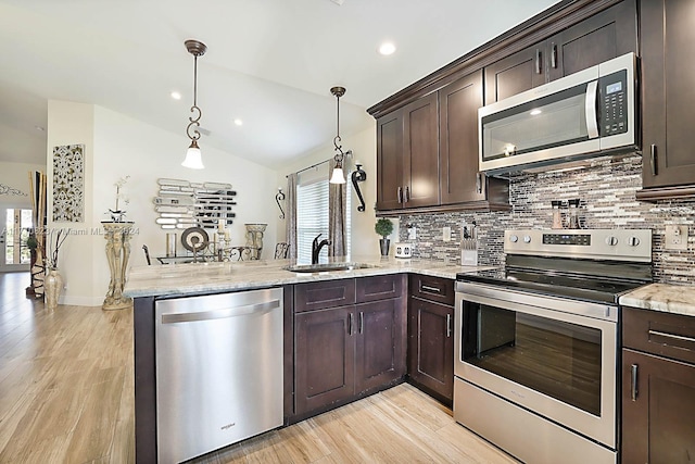 kitchen with sink, decorative light fixtures, dark brown cabinets, kitchen peninsula, and stainless steel appliances