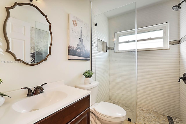 bathroom featuring vanity, toilet, and an enclosed shower