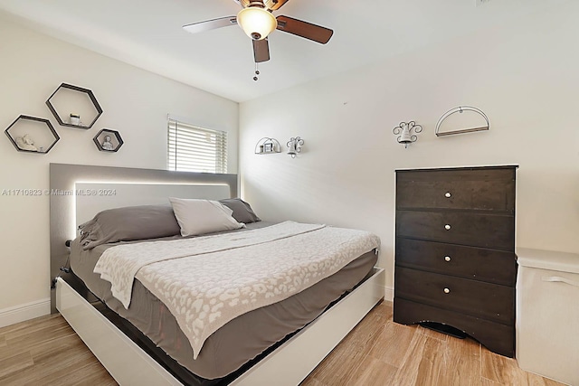 bedroom with ceiling fan and light hardwood / wood-style floors