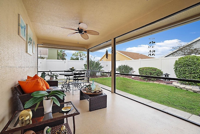 sunroom / solarium featuring ceiling fan