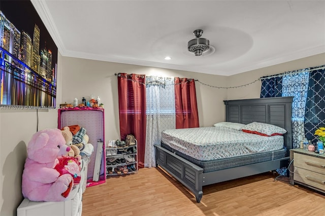 bedroom featuring ceiling fan, crown molding, and light wood-type flooring