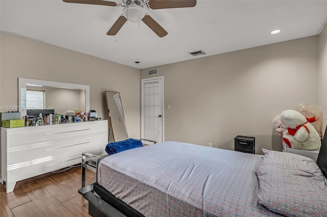 bedroom with ceiling fan and hardwood / wood-style floors