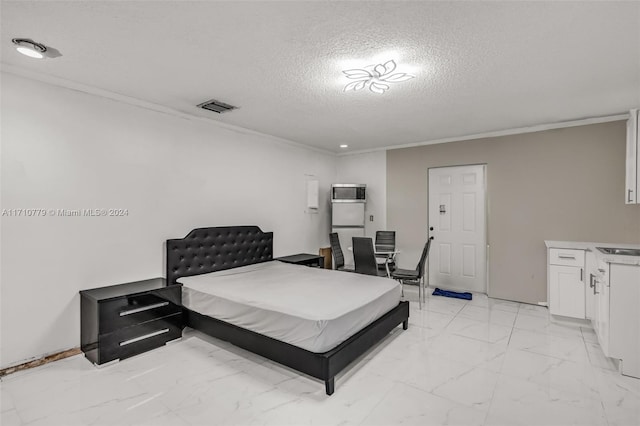 bedroom featuring crown molding and a textured ceiling