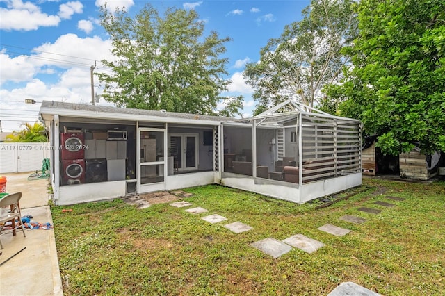 back of property featuring a sunroom and a yard