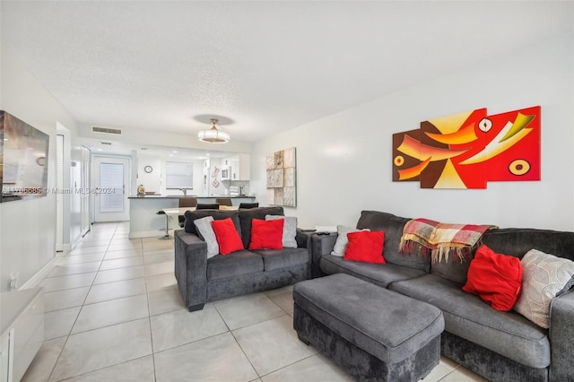 living room with light tile patterned floors and a textured ceiling