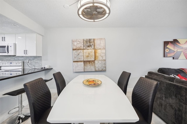 dining area featuring a textured ceiling