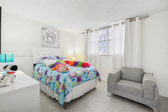 tiled bedroom featuring a textured ceiling