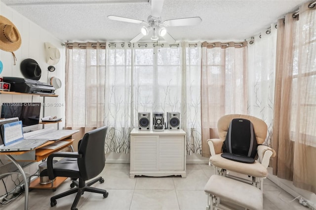 tiled home office featuring ceiling fan and a textured ceiling