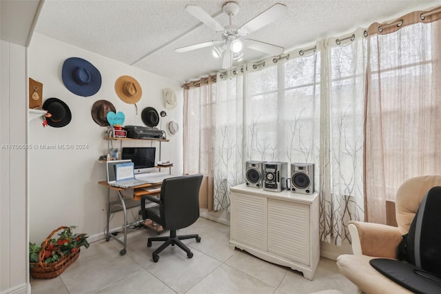 tiled office featuring a textured ceiling, a wealth of natural light, and ceiling fan