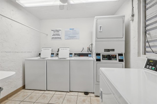 washroom featuring washing machine and dryer, ceiling fan, light tile patterned flooring, and stacked washer / drying machine