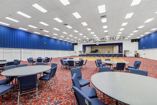 interior space featuring a paneled ceiling and carpet floors