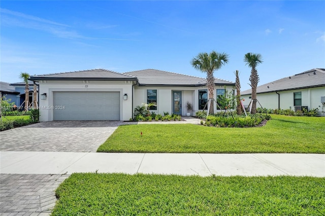 4536 N Silverwood Ln N, Oakland Park, FL 33309 - view of front of home featuring a tile roof, a garage, decorative driveway, and stucco siding