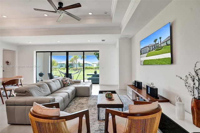living room with a tray ceiling, recessed lighting, ornamental molding, and a ceiling fan