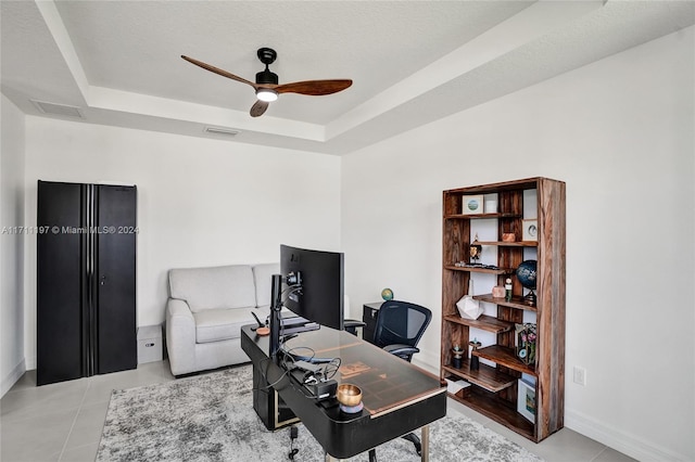 4536 N Silverwood Ln N, Oakland Park, FL 33309 - office featuring a tray ceiling, light tile patterned floors, baseboards, visible vents, and a ceiling fan