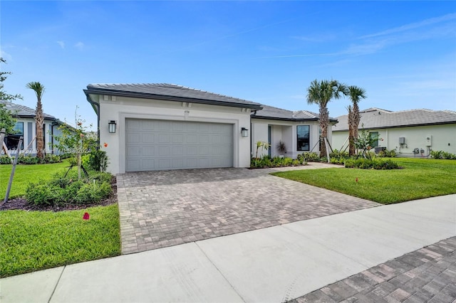 4536 N Silverwood Ln N, Oakland Park, FL 33309 - view of front of house with stucco siding, a garage, a front yard, and decorative driveway