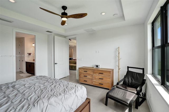 4536 N Silverwood Ln N, Oakland Park, FL 33309 - bedroom with connected bathroom, light tile patterned floors, a tray ceiling, and visible vents