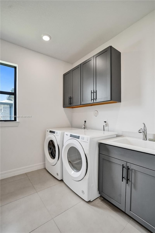 4536 N Silverwood Ln N, Oakland Park, FL 33309 - laundry room with light tile patterned floors, baseboards, separate washer and dryer, a sink, and cabinet space