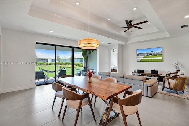 4536 N Silverwood Ln N, Oakland Park, FL 33309 - dining space with a tray ceiling, crown molding, light tile patterned floors, visible vents, and ceiling fan