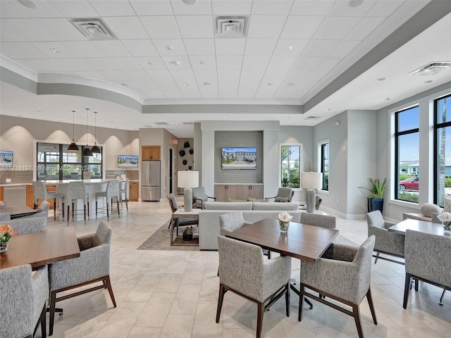 4536 N Silverwood Ln N, Oakland Park, FL 33309 - dining area with ornamental molding, a tray ceiling, baseboards, and visible vents