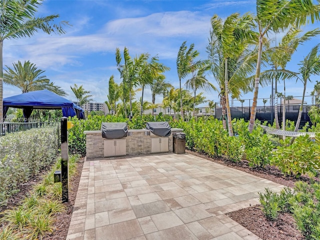 4536 N Silverwood Ln N, Oakland Park, FL 33309 - view of patio with an outdoor kitchen, fence, and a grill