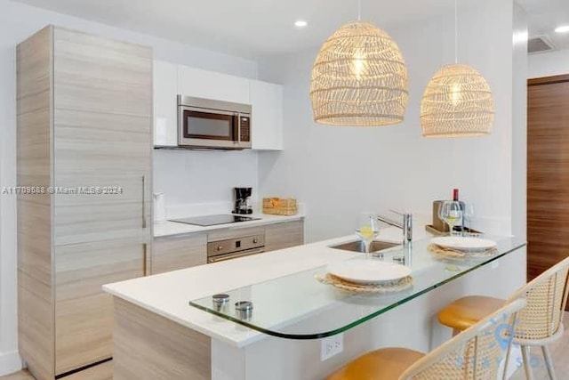 kitchen with white cabinetry, sink, and appliances with stainless steel finishes