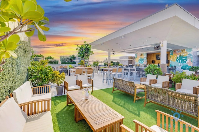 patio terrace at dusk featuring an outdoor living space