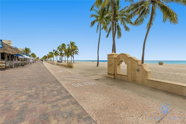 view of road with a water view and a view of the beach