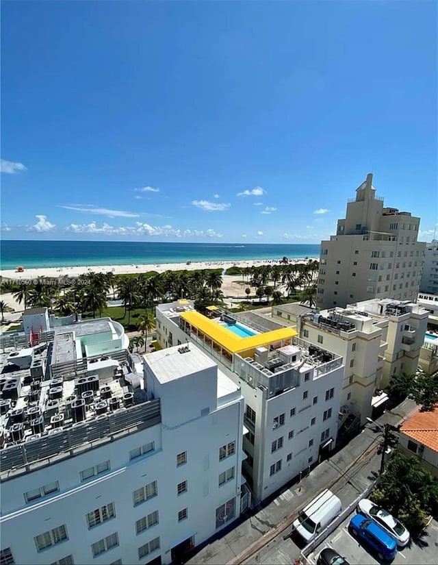 bird's eye view with a water view and a beach view