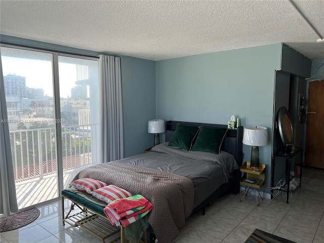 tiled bedroom with a textured ceiling and access to outside