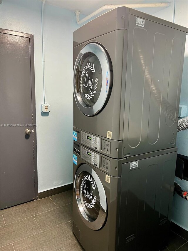 clothes washing area featuring stacked washer and clothes dryer