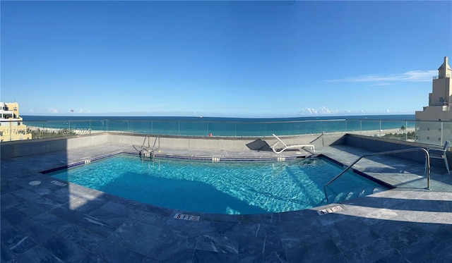 view of pool with a water view