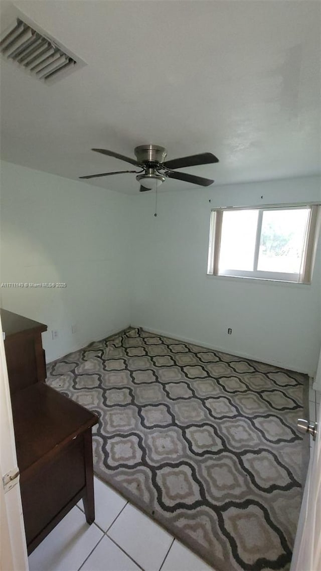 unfurnished bedroom featuring ceiling fan and light tile patterned floors