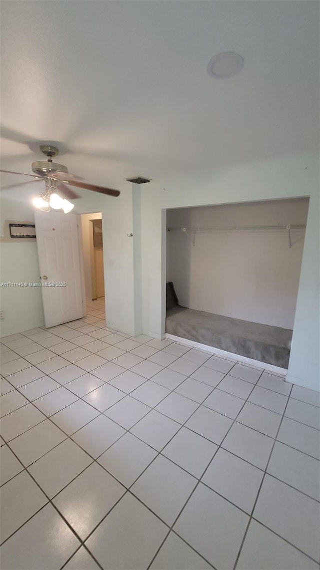 unfurnished bedroom featuring ceiling fan and light tile patterned flooring