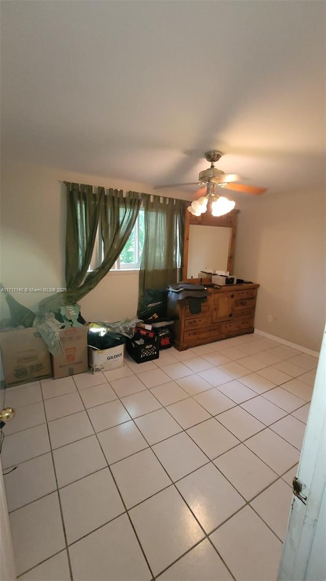 unfurnished bedroom with ceiling fan and light tile patterned flooring