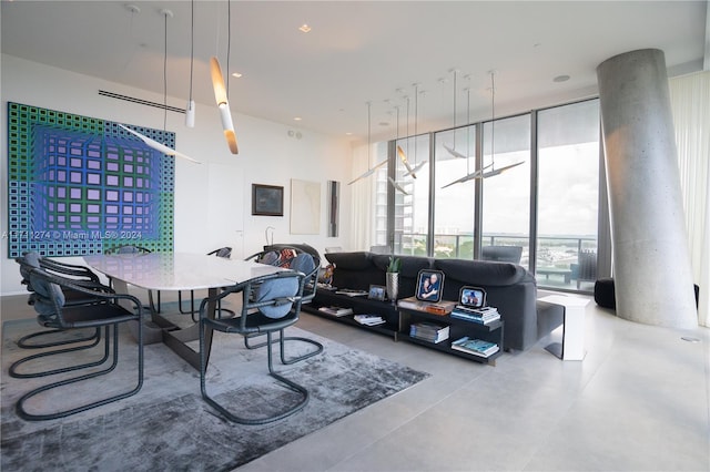 living room featuring expansive windows and concrete floors