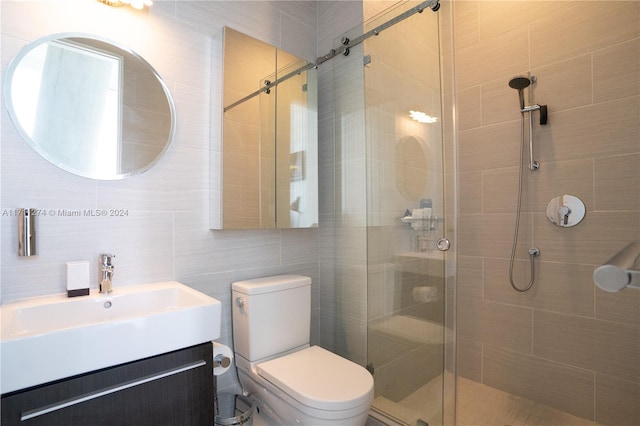 bathroom featuring walk in shower, vanity, toilet, and tile walls