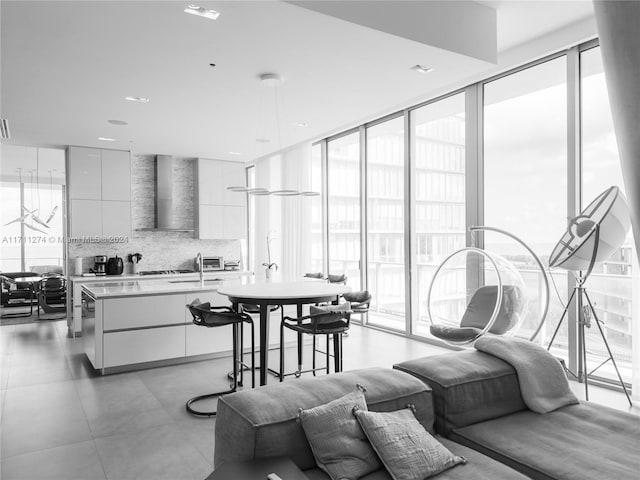 living room with floor to ceiling windows and sink