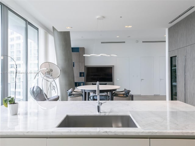 kitchen featuring light stone countertops and sink