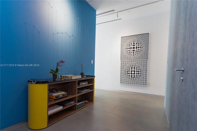 hall featuring concrete flooring