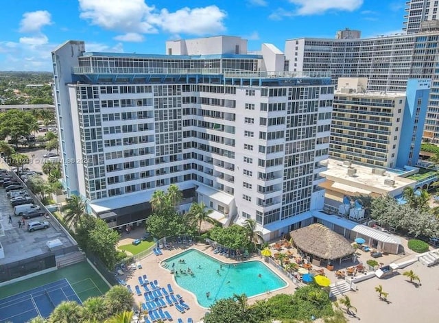 view of building exterior featuring a community pool