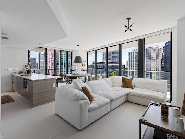 living room featuring expansive windows and sink