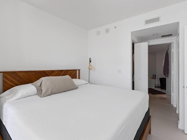 bedroom featuring light tile patterned flooring