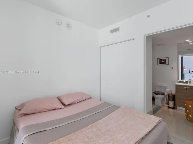 tiled bedroom with a closet